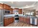 Well-equipped kitchen features stainless steel appliances, granite countertops, and stylish wood flooring at 4905 Lilium Dr, Plainfield, IN 46168