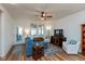 Bright living room with wood floors, a blue sofa, and access to a patio at 4905 Lilium Dr, Plainfield, IN 46168