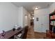 Office space with a desk, chair, and ample storage; hallway view at 4905 Lilium Dr, Plainfield, IN 46168