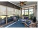 Cozy sunroom featuring wicker furniture, a blue carpet, and natural light from the surrounding windows at 4905 Lilium Dr, Plainfield, IN 46168