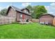 Spacious backyard with a charming deck, dining set, and lush green lawn at 514 E 2Nd St, Sheridan, IN 46069