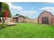 Expansive backyard featuring two storage sheds and a lovely outdoor seating area at 514 E 2Nd St, Sheridan, IN 46069