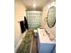 Charming bathroom with an oval mirror and decorative shower curtain at 514 E 2Nd St, Sheridan, IN 46069