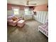 Cozy bedroom with neutral carpet, pink walls, and board and batten trim at 514 E 2Nd St, Sheridan, IN 46069