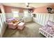 Cozy bedroom with neutral carpet, pink walls, and board and batten trim at 514 E 2Nd St, Sheridan, IN 46069