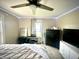 Bright bedroom with a ceiling fan, natural light, and simple, modern decor at 514 E 2Nd St, Sheridan, IN 46069