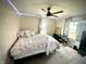 Cozy bedroom with neutral tones, plush bedding, and a modern ceiling fan at 514 E 2Nd St, Sheridan, IN 46069