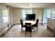 Bright dining room featuring a round table, four chairs, a neutral rug, and large windows for ample natural light at 514 E 2Nd St, Sheridan, IN 46069