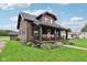 Charming home with a covered porch, lush lawn, and well-maintained landscaping, providing an inviting curb appeal at 514 E 2Nd St, Sheridan, IN 46069