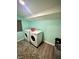 Well-lit laundry area equipped with modern, front-loading washer and dryer units at 514 E 2Nd St, Sheridan, IN 46069