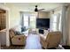 Cozy living room with comfortable seating, a ceiling fan, a television, and plenty of natural light from multiple windows at 514 E 2Nd St, Sheridan, IN 46069