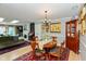 Elegant dining room featuring a round table, chandelier, and access to the kitchen and living area at 5333 Thicket Hill Ln, Indianapolis, IN 46226