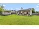 Expansive backyard with a pergola-covered patio, a shed, lush green lawn, and a wood fence at 59 Millet Ct, Danville, IN 46122