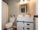 A neutral bathroom features a vanity with a sliding door, a toilet, and a shower at 59 Millet Ct, Danville, IN 46122