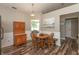 An inviting dining area features a wooden table, chairs, and a vintage hutch near a window at 59 Millet Ct, Danville, IN 46122