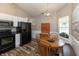 Well-lit kitchen features black appliances and a wooden table with chairs beside a large window at 59 Millet Ct, Danville, IN 46122