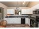 Well-lit kitchen with white cabinetry and stainless steel microwave oven at 59 Millet Ct, Danville, IN 46122