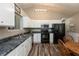 Bright kitchen with white cabinets, dark countertops, and modern appliances at 59 Millet Ct, Danville, IN 46122