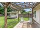 View of pergola-covered patio with rocking chairs and a shed in the backyard at 59 Millet Ct, Danville, IN 46122
