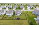Aerial view showcasing a home with a large, fenced backyard, play area, and manicured lawn in a neighborhood at 6137 Hardwick Dr, Whitestown, IN 46075