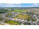 An aerial view of a residential area showcasing multiple homes, open fields and a water tower in the distance at 6137 Hardwick Dr, Whitestown, IN 46075