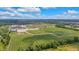 An aerial view showcases a sports complex featuring various athletic fields amidst a community under a sunny sky at 6137 Hardwick Dr, Whitestown, IN 46075