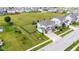 Aerial shot of a home with a spacious, fenced backyard featuring a play area and manicured landscaping at 6137 Hardwick Dr, Whitestown, IN 46075