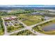 An aerial view displaying a school, ponds, and athletic fields alongside an intersection and roadways at 6137 Hardwick Dr, Whitestown, IN 46075