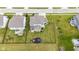 A home's backyard features a patio, play set and generous lawn space surrounded by a black chain link fence at 6137 Hardwick Dr, Whitestown, IN 46075