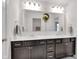 Bathroom featuring double sinks with quartz counters, dark cabinets and modern fixtures at 6137 Hardwick Dr, Whitestown, IN 46075
