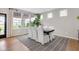 Bright dining room features large windows and a modern table with white upholstered chairs at 6137 Hardwick Dr, Whitestown, IN 46075
