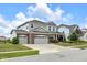 Beautiful exterior of a two-story home with a three-car garage and large driveway at 6137 Hardwick Dr, Whitestown, IN 46075
