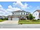 Charming two-story home features a three-car garage and professionally landscaped front yard at 6137 Hardwick Dr, Whitestown, IN 46075