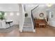 Foyer view features staircase with iron railing, wood floors, and stylish accents at 6137 Hardwick Dr, Whitestown, IN 46075