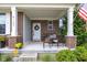 Cozy front porch with seating area, plants, and a decorative wreath on the front door at 6137 Hardwick Dr, Whitestown, IN 46075