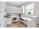 Bright home office offers built-in desks, overhead cabinets, and plenty of natural light from the window at 6137 Hardwick Dr, Whitestown, IN 46075