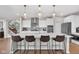 Bright kitchen features white cabinets, stainless appliances, an island with seating, and modern pendant lighting at 6137 Hardwick Dr, Whitestown, IN 46075