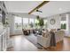 Large living room boasts ample windows, cozy seating, and a fireplace with custom shelving at 6137 Hardwick Dr, Whitestown, IN 46075