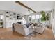 Bright living room with fireplace, built-in shelving, large windows, neutral decor, and a comfortable seating area at 6137 Hardwick Dr, Whitestown, IN 46075