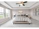 Serene main bedroom with tray ceiling, large windows, and elegant decor for a relaxing retreat at 6137 Hardwick Dr, Whitestown, IN 46075