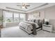 Serene main bedroom with tray ceiling, large windows, and elegant decor for a relaxing retreat at 6137 Hardwick Dr, Whitestown, IN 46075