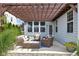Charming patio with pergola, comfortable seating, and manicured landscaping for outdoor relaxation at 6137 Hardwick Dr, Whitestown, IN 46075