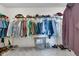 Spacious walk-in closet with ample storage, including hanging rods, shelves, and shoe racks for organization at 6137 Hardwick Dr, Whitestown, IN 46075