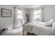 Bright bedroom with white walls, soft carpet, and large windows offering natural light at 7082 Muskrat Dr, Nineveh, IN 46164