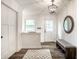 Bright entryway with white walls, modern light fixture, decorative mirror, and bench creating an inviting space at 7082 Muskrat Dr, Nineveh, IN 46164