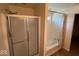 Bathroom showcasing a glass-doored shower and a corner tub with curtain rod at 7532 Gold Rush Ct, Camby, IN 46113