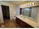 Bathroom with brown vanity and toilet, as well as a shower seen in the mirror at 7532 Gold Rush Ct, Camby, IN 46113