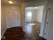 Welcoming foyer with hardwood flooring and natural light from a window in the living area at 7532 Gold Rush Ct, Camby, IN 46113