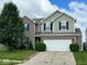 Two-story home with attached two car garage, brick and vinyl siding, and well manicured lawn at 7532 Gold Rush Ct, Camby, IN 46113