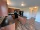 Kitchen with wood cabinets, dark countertops, mosaic backsplash, black appliances, and wood flooring at 7532 Gold Rush Ct, Camby, IN 46113